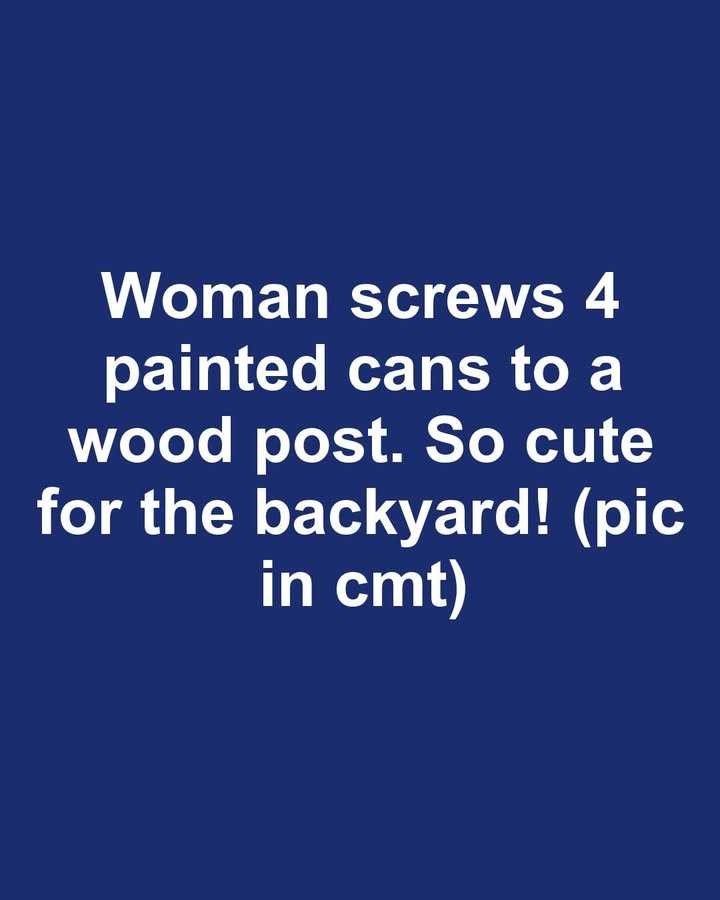 Woman screws 4 painted cans to a wood post. So cute for the backyard!